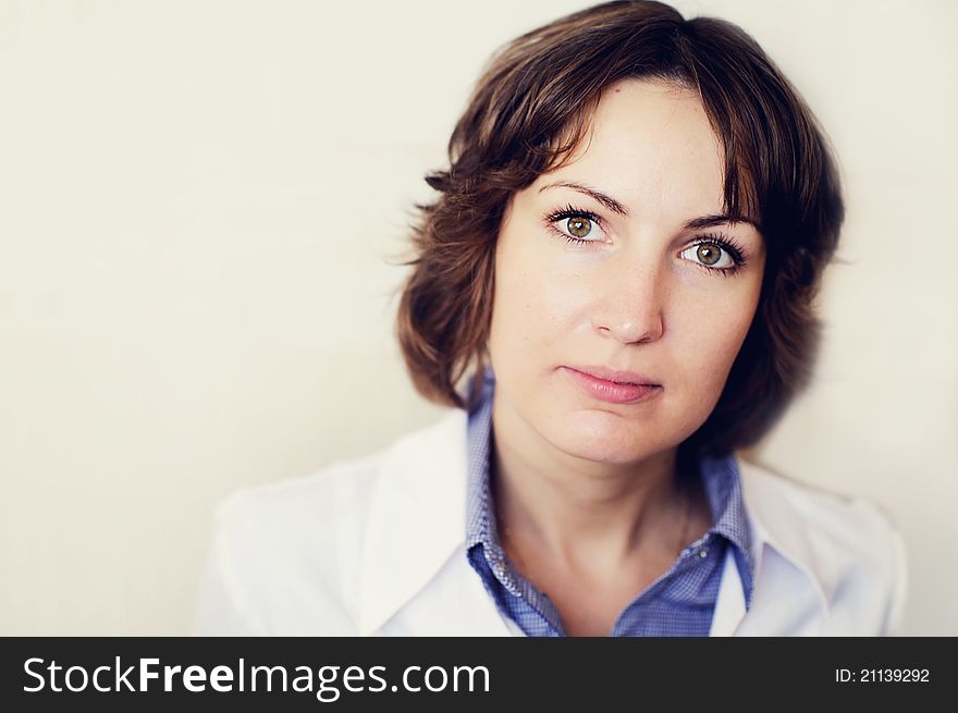 Portrait of a female doctor against a white wall