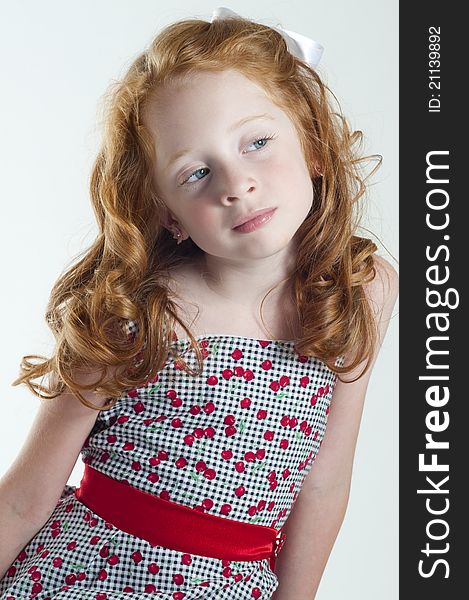 Cute little girl with red hair thinking. Cute little girl with red hair thinking