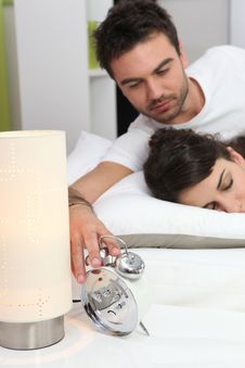 Couple In Bed Waking Up Royalty Free Stock Image