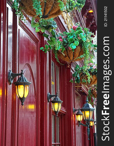 Vintage red facade with decorative lights and suspended flowers. Vintage red facade with decorative lights and suspended flowers