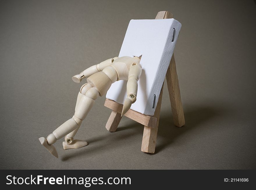 An artists mannequin with head pushed into canvas. An artists mannequin with head pushed into canvas.