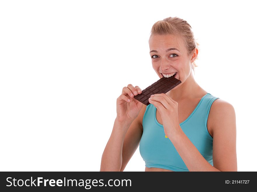 A young beautiful woman is eating a bar of chocolate. A young beautiful woman is eating a bar of chocolate