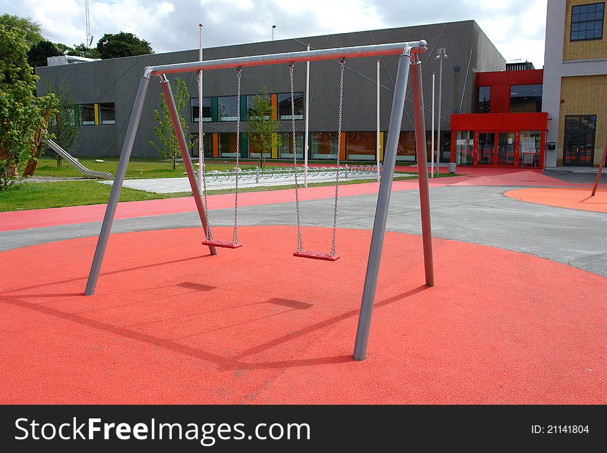 Modern design metal swing in a new city playground. Modern design metal swing in a new city playground