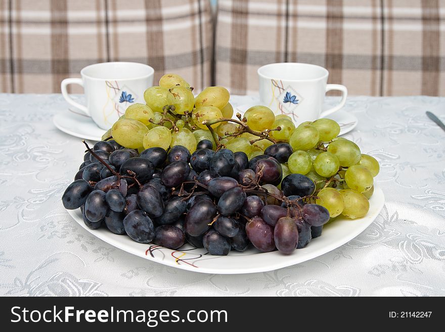 Grapes and cups on the table. Grapes and cups on the table