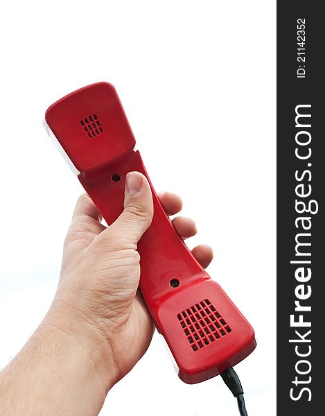 Red old telephone in hand