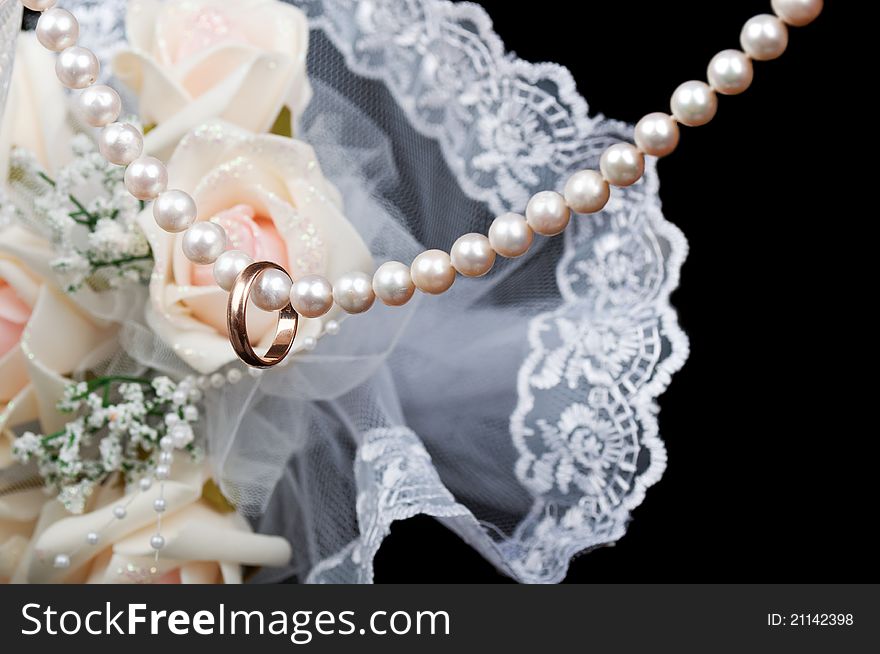 Gold wedding ring on a pearl necklace