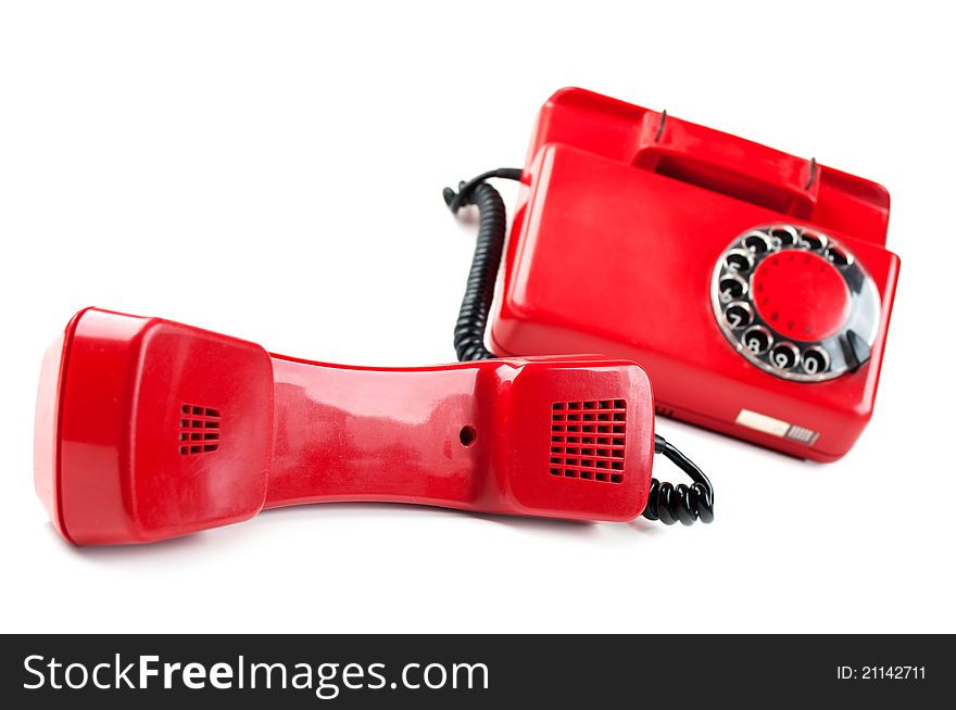 Old and red telephone isolated on a white background. Old and red telephone isolated on a white background