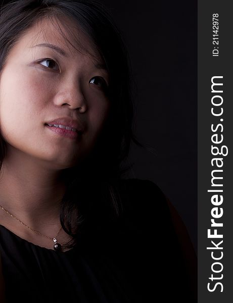 Beautiful Chinese woman with soft look isolated on black. Beautiful Chinese woman with soft look isolated on black