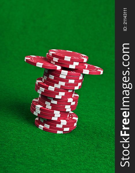 Poker chips on a green table background