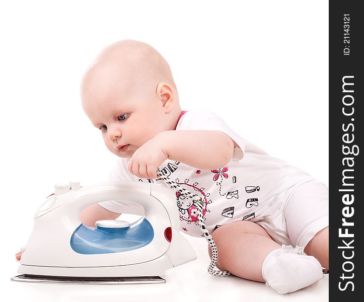 Sweet baby girl playing with iron. Isolated over white background. Sweet baby girl playing with iron. Isolated over white background