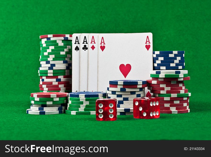 Four aces and poker chips on a green felt