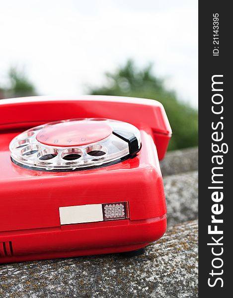 Red phone on the roof of the house