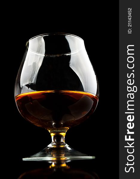 Whiskey in a classic glass isolated on a black background