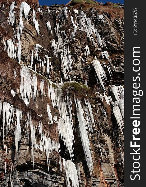 Frozen icicles on a cliff face