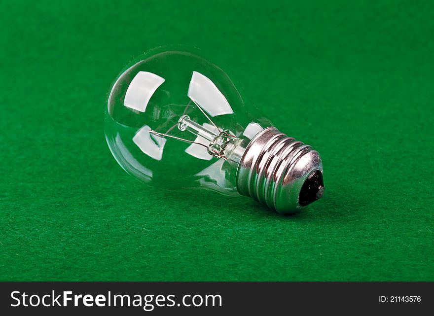 One bulb lamp on a green tissue background