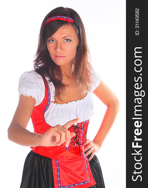 The girl in a traditional Bavarian dress with full glasses of beer in hands