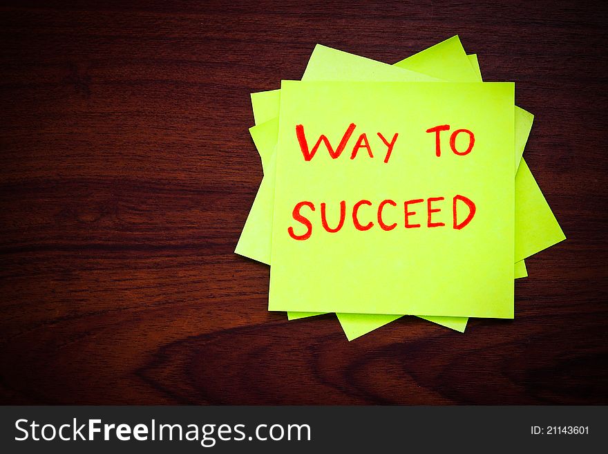 Way to succeed on yellow sticky note against wood wall