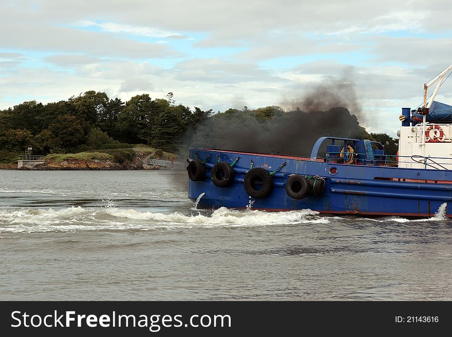 Tug boat on the river shannon at foynes in ireland with diesel fumes. Tug boat on the river shannon at foynes in ireland with diesel fumes