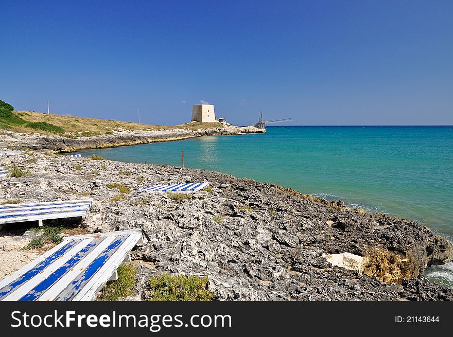 Bay of Manacore, near Peschici, with an ancient Torre Saracena, typical lookout tower of the coast of Gargano. Apulia. Italy. Bay of Manacore, near Peschici, with an ancient Torre Saracena, typical lookout tower of the coast of Gargano. Apulia. Italy.