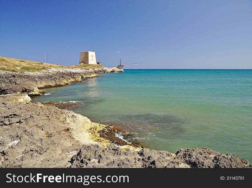 Bay of Manacore, near Peschici, with an ancient Torre Saracena, typical lookout tower of the coast of Gargano. Apulia. Italy. Bay of Manacore, near Peschici, with an ancient Torre Saracena, typical lookout tower of the coast of Gargano. Apulia. Italy.