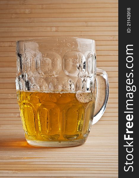 Fresh glass of beer on a wooden table