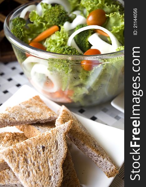 Healthy food green salad with wheat toasts