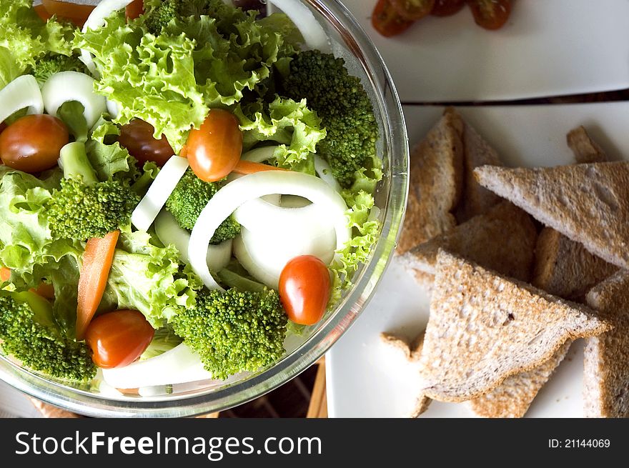 Mixed salad in bowl and wheat bread. Mixed salad in bowl and wheat bread