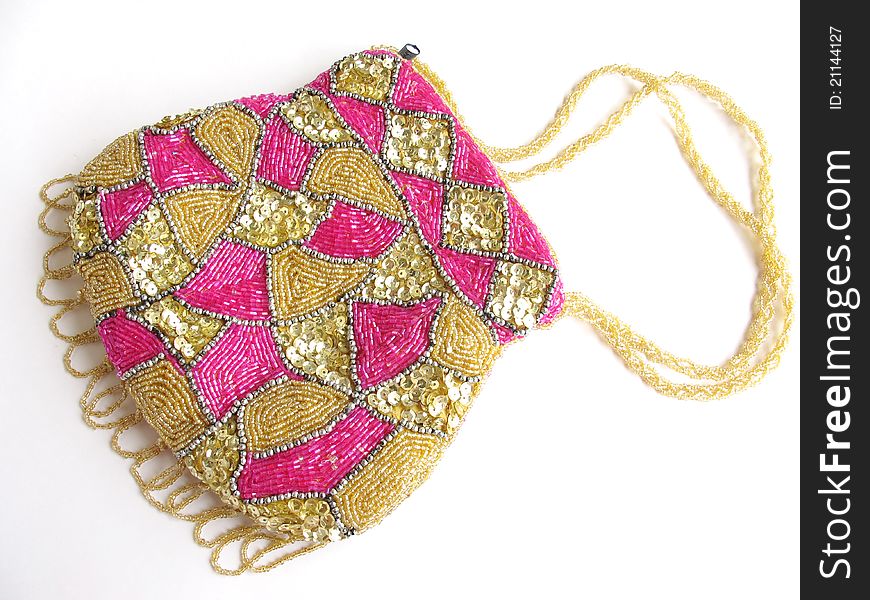 A purse decorated with beads and sequences work on white background. A purse decorated with beads and sequences work on white background.