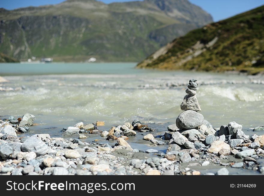 Cairn on the shore of a mountain lake in Austria