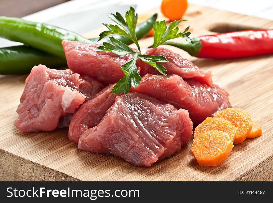 Chopped raw meat on a chopping board. Chopped raw meat on a chopping board