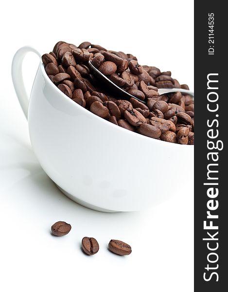 Full cup with coffee beans isolated on a white background