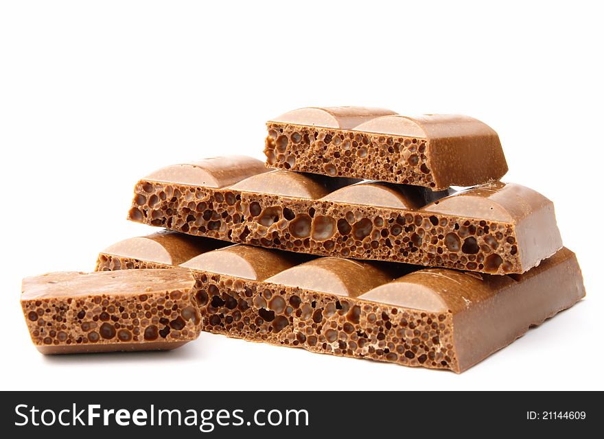 Broken chocolate bar on a white background. Broken chocolate bar on a white background