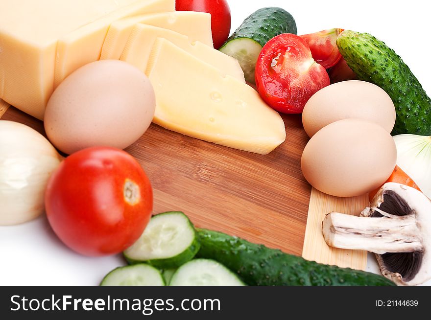 Cheese and fresh vegetables isolated on a white background