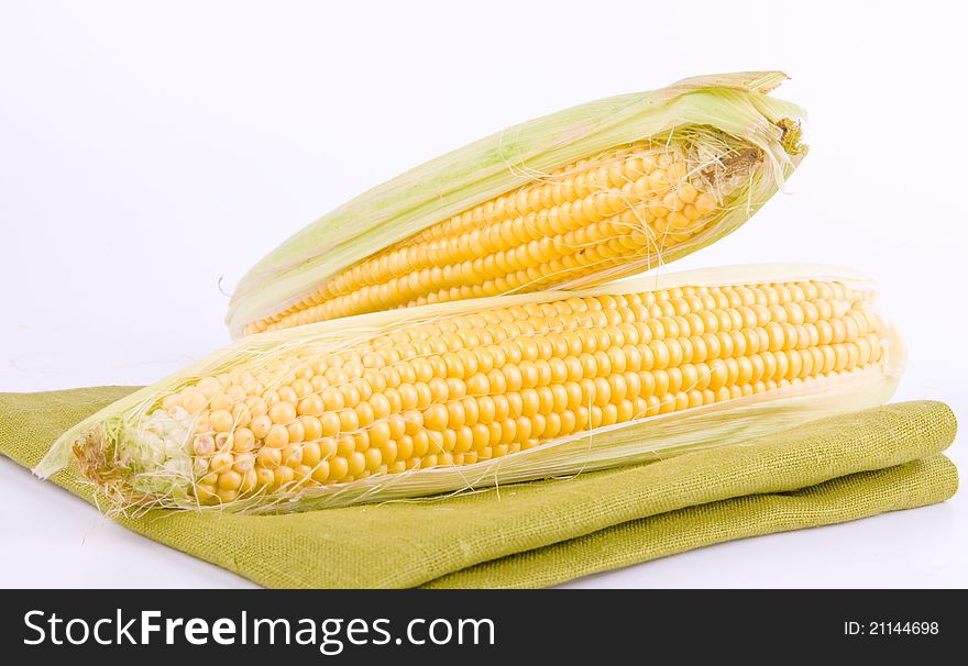 Corn on a white background and green texture