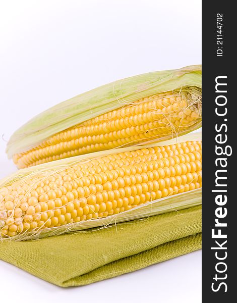 Corn on a white background and green texture