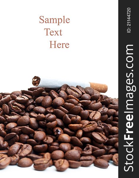 Roasted coffee beans and cigarettes isolated on a white background