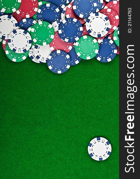 Poker chips on a green table background. Poker chips on a green table background