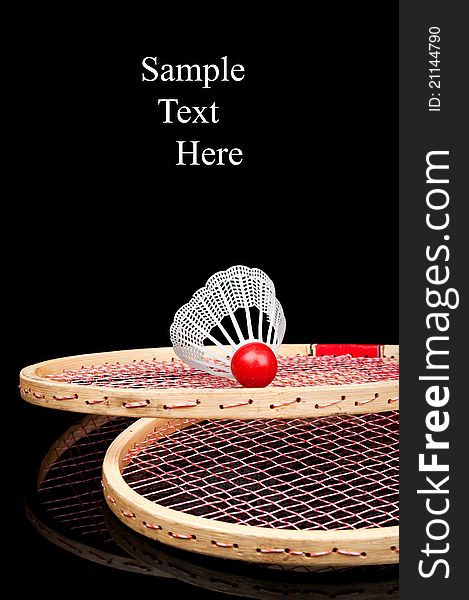 Old badminton and red shuttlecock isolated on a black background