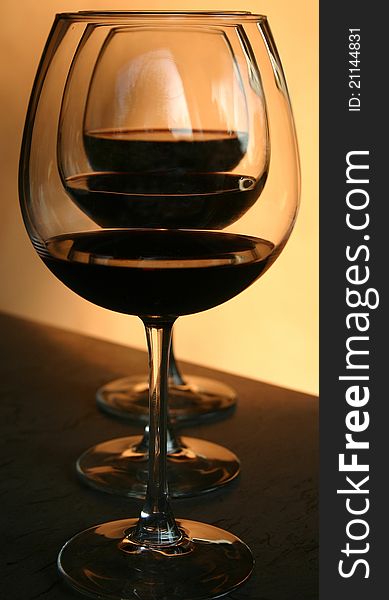 Three chalices of an aged red wine in a warm light. Three chalices of an aged red wine in a warm light