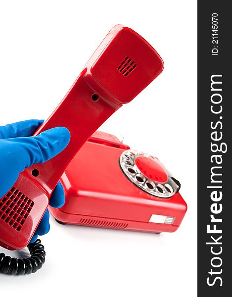 Man in blue gloves picked it up the red phone isolated on a white background