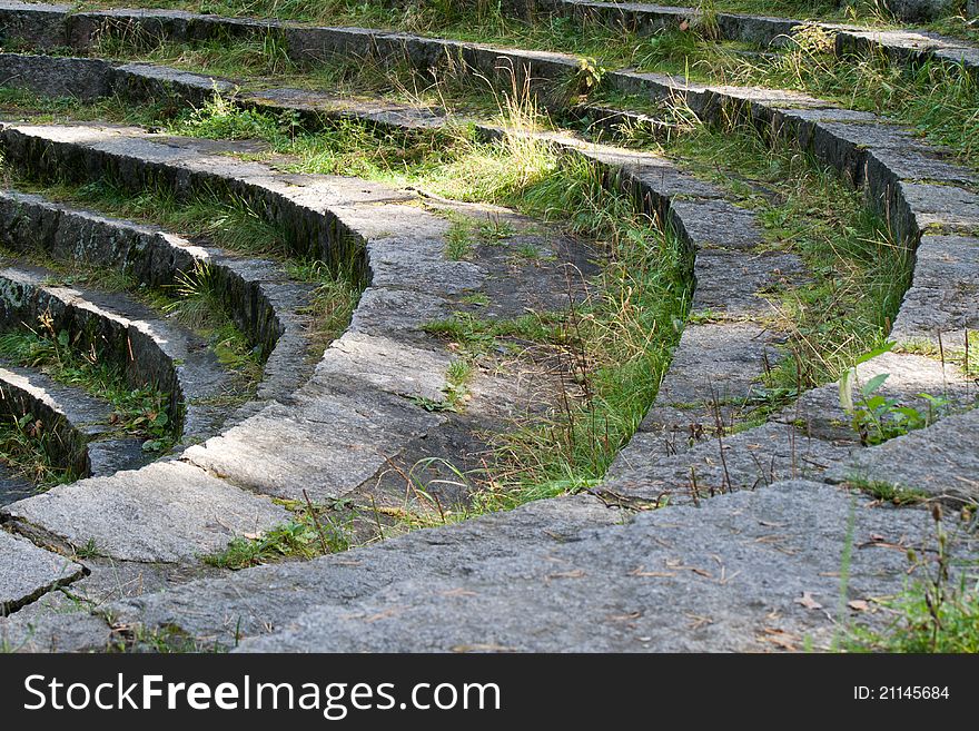 The steps of the old stone stairs in the shape of the amphitheater. The steps of the old stone stairs in the shape of the amphitheater