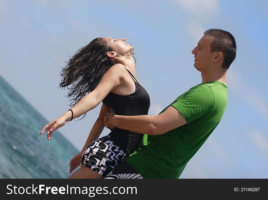 Young men and women walking on the shore of the Mediterranean Sea. Young men and women walking on the shore of the Mediterranean Sea.