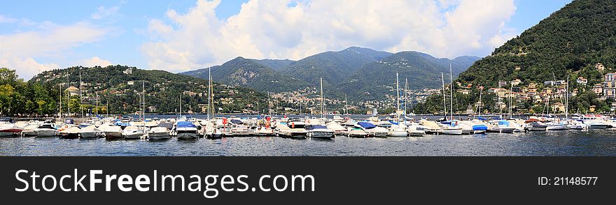 Panoramic view on lake Como, yachts and mountains from the quay in town of Como. Panoramic view on lake Como, yachts and mountains from the quay in town of Como