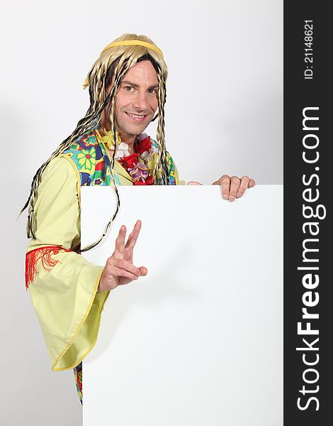 Man dressed in hippy costume holding message