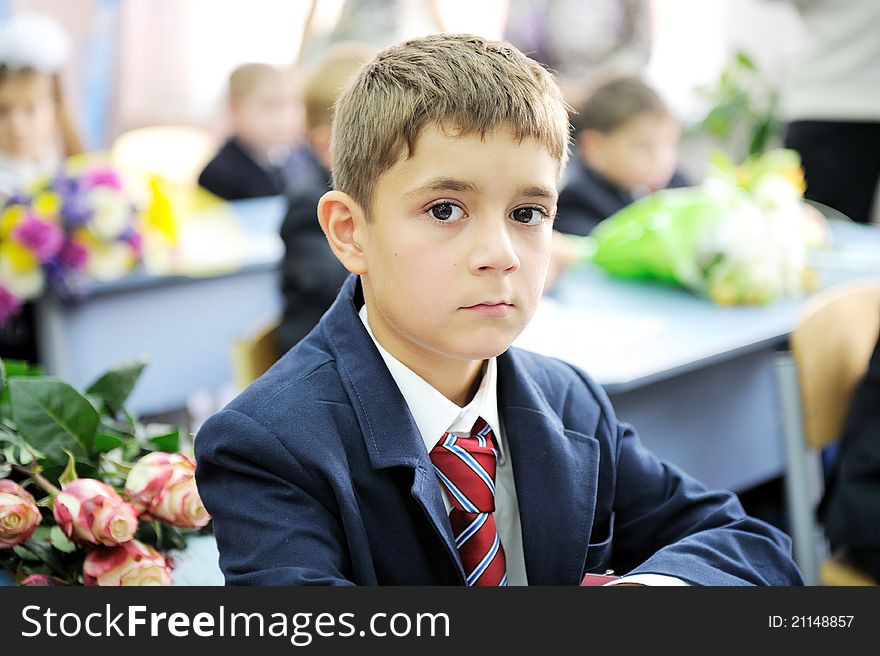 Portrait of first-grader boy sitting at his desk