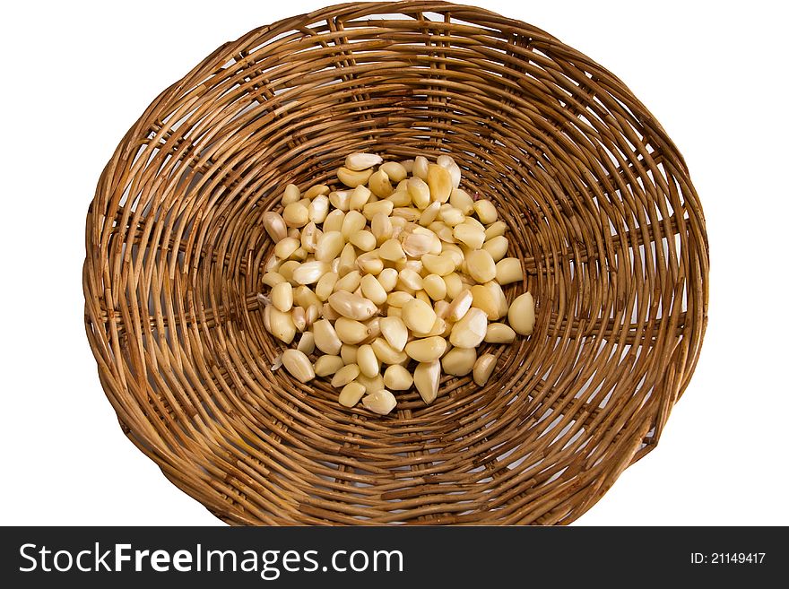 Clove of garlic in bamboo basket isolated on white background