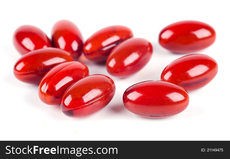 Studio shot of red capsules on white background