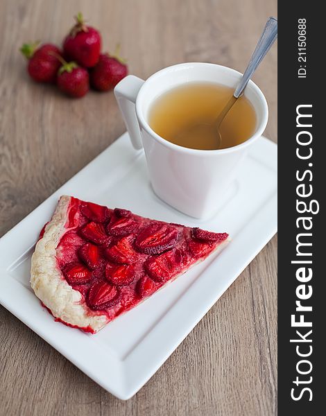 Close-up homemade strawberry pie and a cup of tea