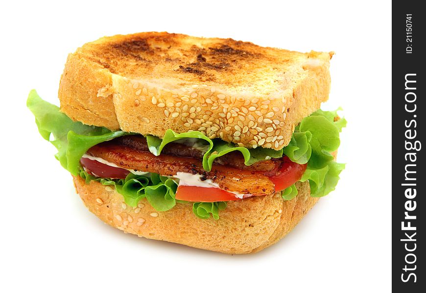 Bacon, Lettuce and Tomato sandwich on lightly toasted thickly sliced homemade bread. Isolated on white background.