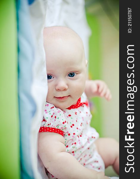 Little smiling baby girl lying in her bed. Little smiling baby girl lying in her bed